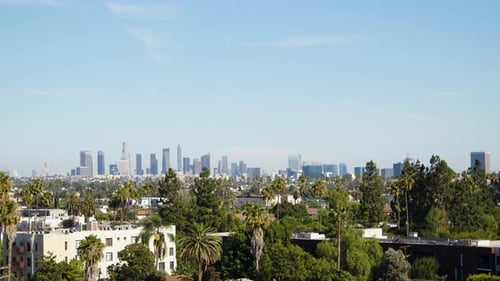 Under the blazing midday sun of a hot summer day, Downtown Los Angeles is seen from Hollywood, facin