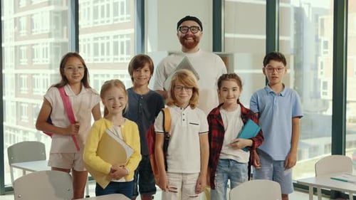 Teacher and Students Smile in Classroom Together
