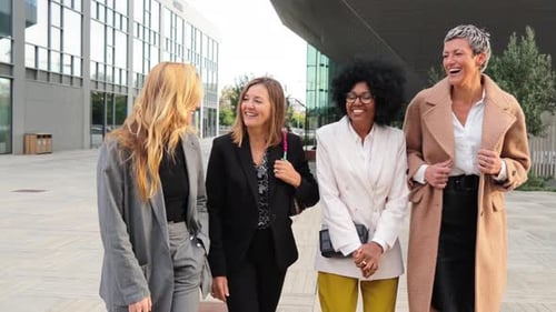 Four Women Walking and Talking Outside Office