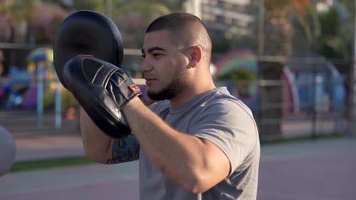 Energizing Morning Routine Guy's Shadowboxing on PalmFringed Basketball Court
