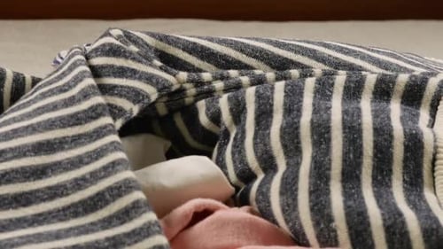 Assorted Clothing Being Placed on a Bed