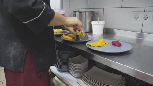 Chef Plating Food in Commercial Kitchen