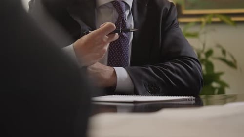 Corporate Businessman at conference interview with pen and papers