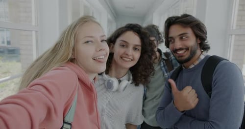 Portrait of Joyful Students Posing for Camera Having Fun Laughing Taking Selfie in High School Lobby