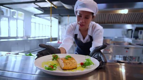 Chef Presents Gourmet Salmon Dish in Kitchen