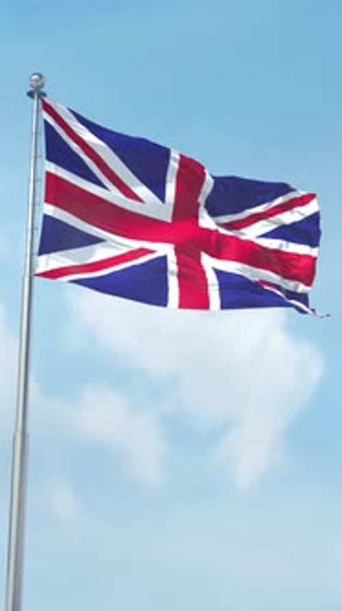 United Kingdom Flag Waving on Flagpole with Blue Sky Background