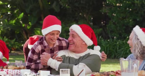 Happy caucasian family having christmas dinner in garden