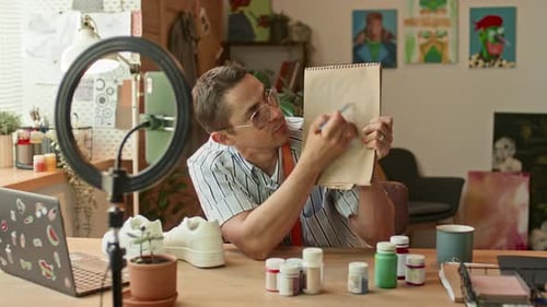 Young Adult Man Drawing and Discussing Sneakers