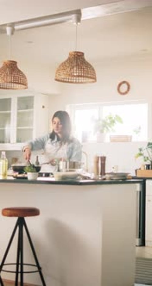 Woman Cooking Food in Bright Kitchen