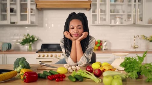 Woman with Vegetables in Bright Modern Kitchen