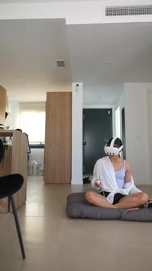 Woman Uses Virtual Reality Headset in Apartment