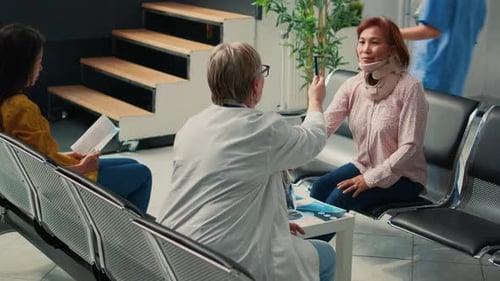 Doctor Consults Patient Wearing Neck Brace in Hospital