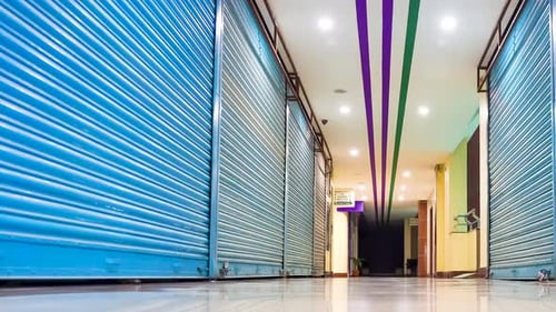 Alley Of A Mall Showing Closed Shops During Lockdown. Low Angle view, PAN