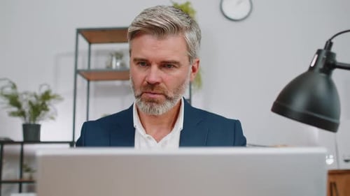 Closeup Businessman Freelancer at Office Workplace Working on Laptop Computer Sends Online Messages