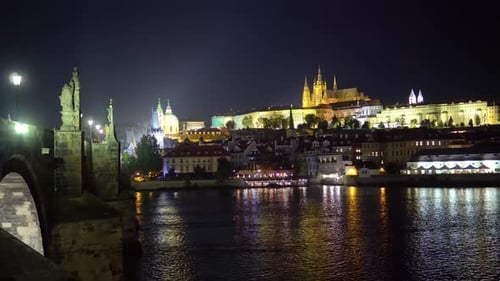 Prague Castle and Charles Bridge above Vltava river at night