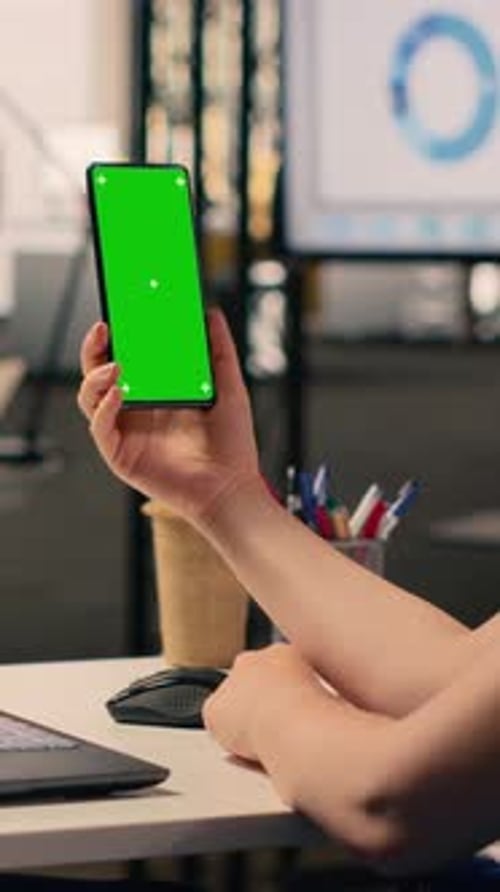 Vertical Video Blue Screen on Laptop and Vertical Green Screen on Smartphone Held By Woman