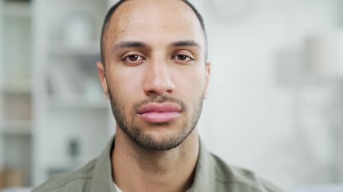 Portrait serious confident young adult man looking at camera indoors. Headshot closeup handsome male