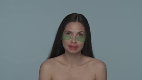 Brunette Woman Doing Facial Skin Care Procedures Woman with Hyaluronic Green Patches Under Her Eyes