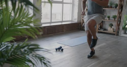 Athletic Man Does High Knees at Home Workout