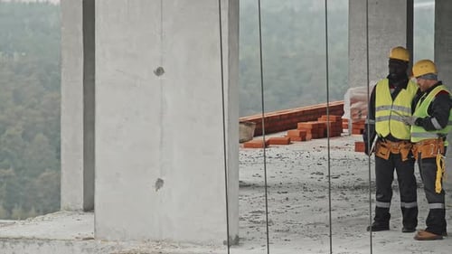 Two Construction Workers Discussing Issues
