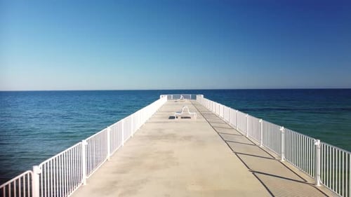 Flight Over the Pier in the Sea on a Sunny Day