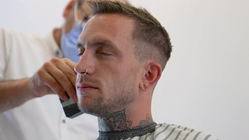 Man Gets Haircut in a Modern Barber Shop