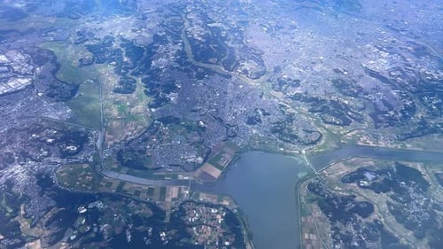 A vast landscape with rivers, cities, and agricultural fields, aerial view