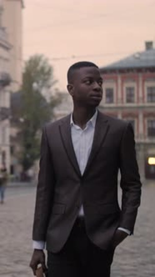 Confident Businessman Walking on Street with Briefcase