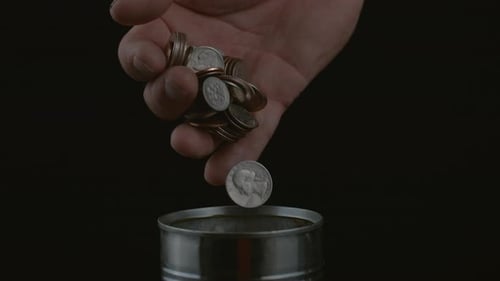 Slow Motion Coin Drop into Can