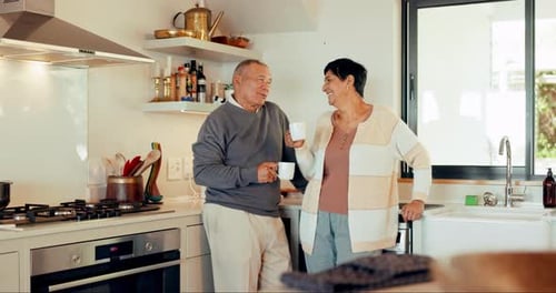 Senior Couple Laughing Together in Kitchen