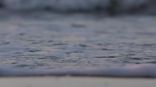 Sea waves rushing at the beach during sunset. Slow Motion Ocean White water Wave surf crashing.