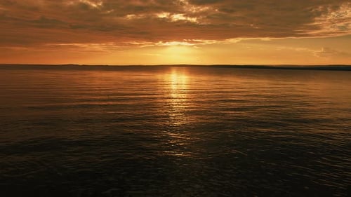 Magical Sunset on the Lake Sun Reflects on Surface of Water and Forms an Orange Path on Small Waves