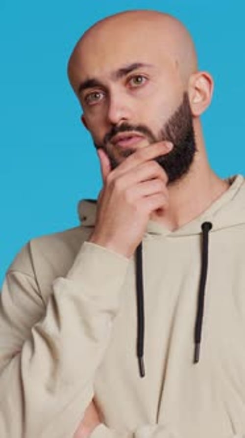 Man With Beard Thinking on Blue Background
