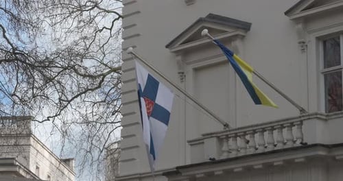 Flags Waving in Front of White Governmental Building