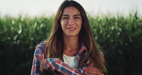 Close Up of a Woman Smiling and Looking Around in a Green Field of Corn. Y