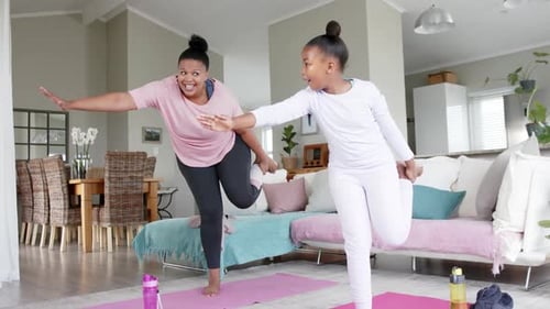 Mother and Daughter Balancing During Home Workout