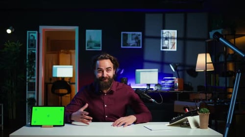 Man Explaining Behind Computer Desk with Tablet