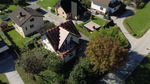 Orbit shot of roof that has been damaged and needing replacement. drone view.