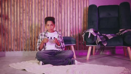 Teen Celebrating Video Game Victory at Home