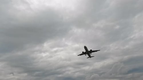 Airplane Arrives to the Airport Over the Wire Fence