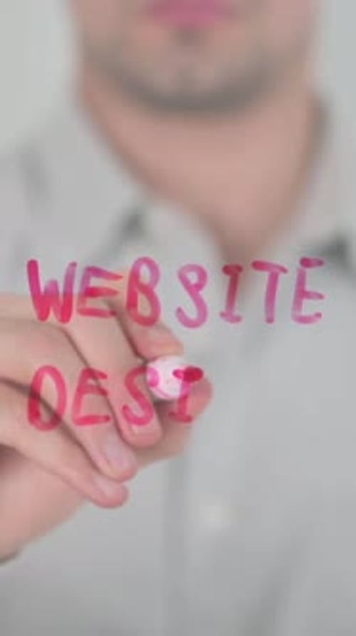 Website Design Written on Glass by Man in Shirt