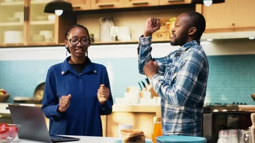 Happy Couple Dancing Together in the Kitchen
