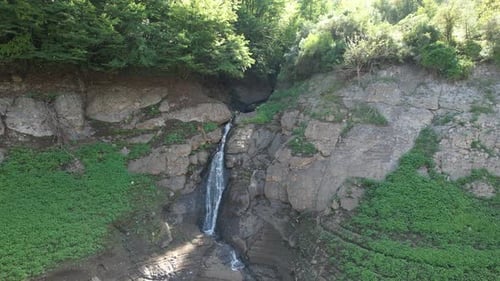 Scenic Waterfall in Lush Green Environment