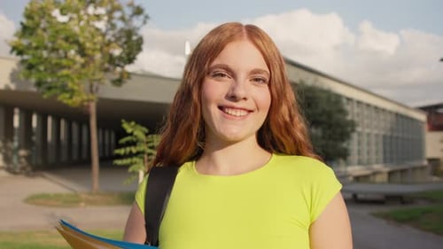 University Student Smiling Holding Folders