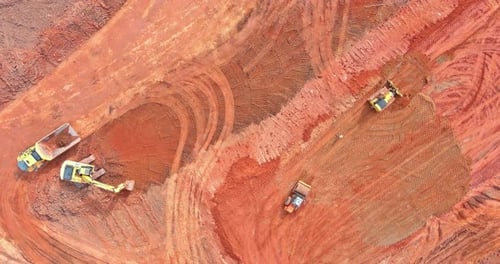 Construction Equipment Working in a Red Dirt Quarry