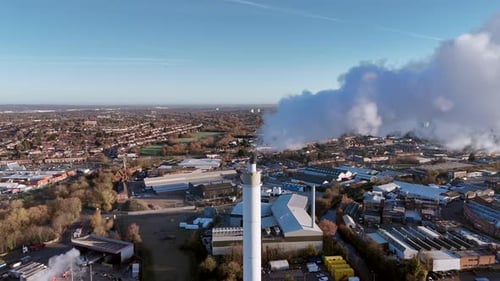 Aerial View of Industrial Smokestack in Urban Area