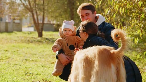 Loving Family and Dog Enjoy Sunny Day in Park