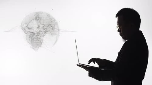 Silhouette of a businessman or computer programmer successfully solving a global problem