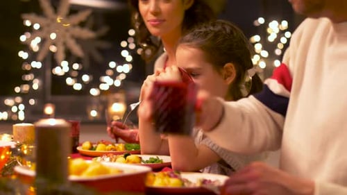 Family christmas dinner with lights and decorations