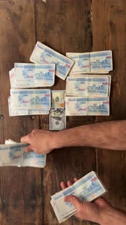 Iran maximum high money banknote vs dollar USD USA bill currency American wooden background 100 bank